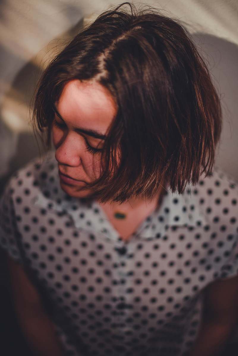 polka dot woman in white and black polka dot shirt wearing black framed eyeglasses human